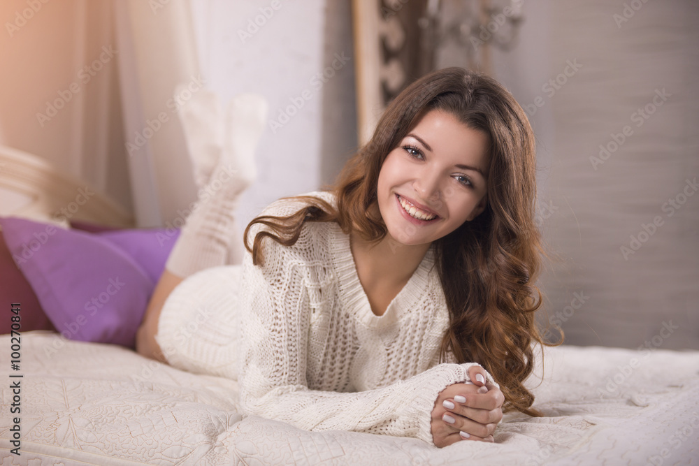 Smiling brown-haired woman on the bed Smiling brown-haired woman on the bed