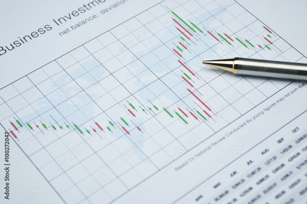 Pencil on stock market graph, financial concept Pencil on stock market graph, financial concept