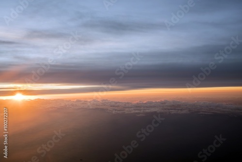 Morning Sun & Cloudy sky from airplane Through window onto jet engine - flying view (window airplane) 