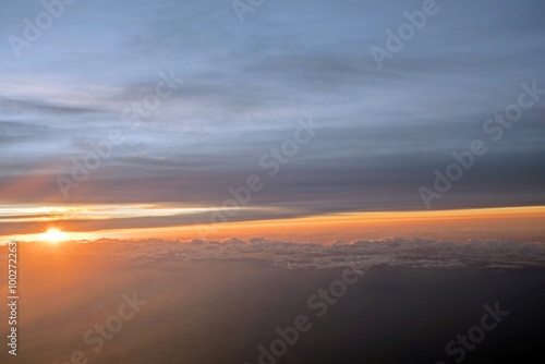 Morning Sun & Cloudy sky from airplane Through window onto jet engine - flying view (window airplane) 