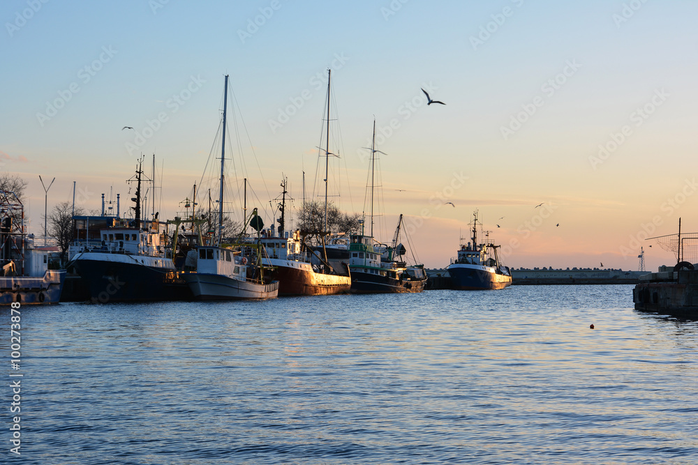 Old fishing trawlers at sunset