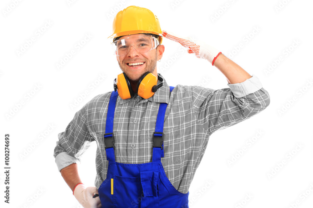 Builder in yellow helmet, protective glasses and working clothes Builder in yellow helmet, protective glasses and working clothes