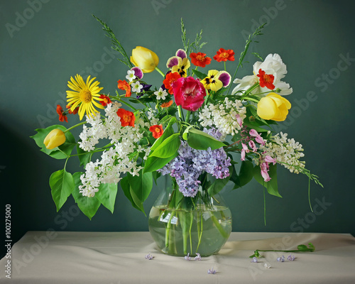 Still life with spring flowers on a green background.
