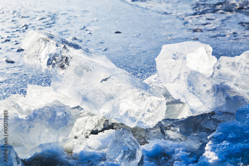 ice blocks on the edge of ice-hole in frozen lake