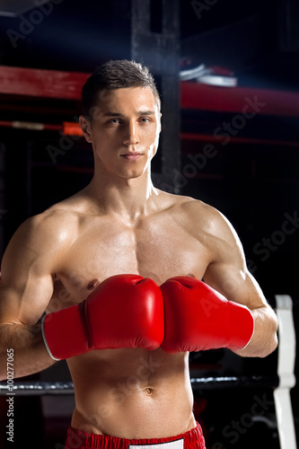 Handsome young sportsman on the boxing ring