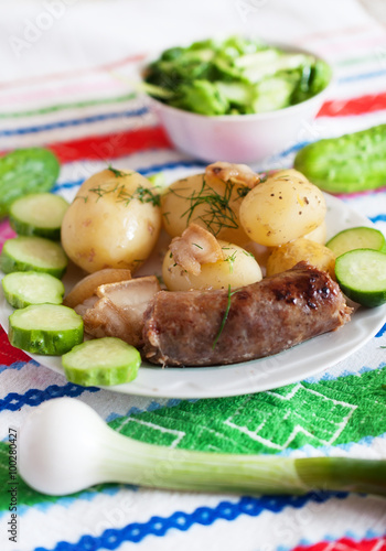 Boiled potatoes with fried bacon photo