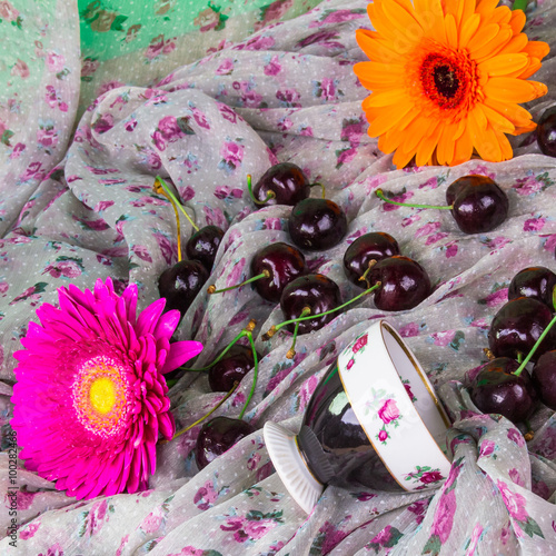 Coffee cups, Gerbera and sweet cherry photo