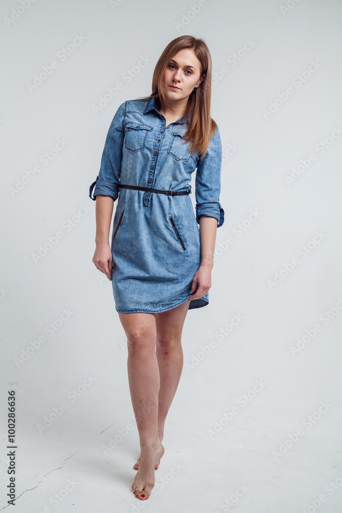Portrait of a girl in a blue denim dress - isolated on white background Portrait of a girl in a blue denim dress - isolated on white background