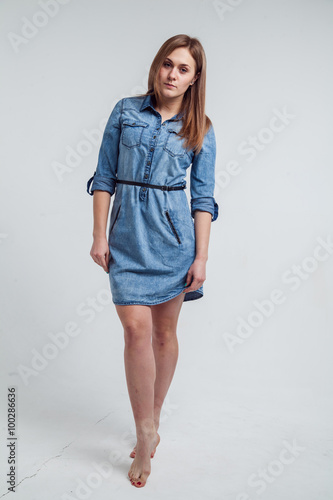 Portrait of a girl in a blue denim dress - isolated on white background © al1188