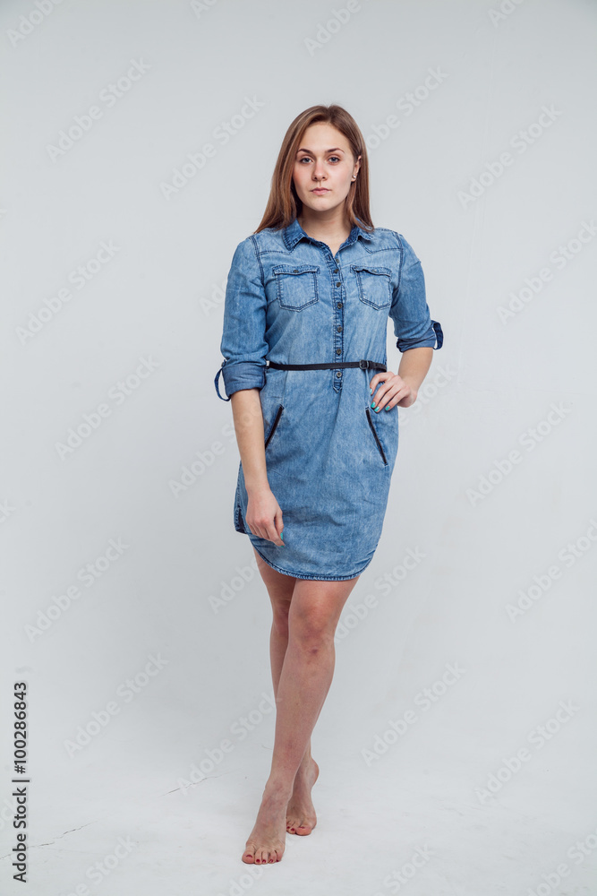Portrait of a girl in a blue denim dress - isolated on white background Portrait of a girl in a blue denim dress - isolated on white background