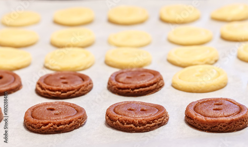 Raw dough. Yellow and brown cookies buttons. Cooking.