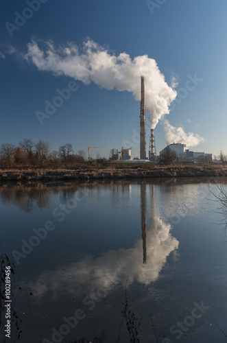 Power plant and overhead pipeline at cold morning over Vistula river  Krakow  Poland