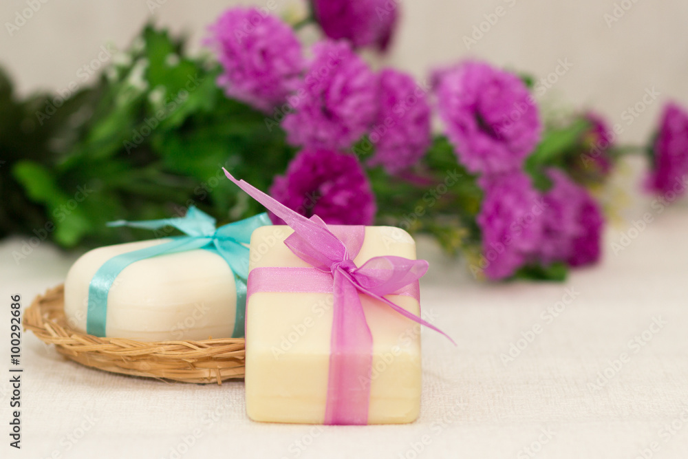 Two pieces of soap with a basket with a bow and flowers Two pieces of soap with a basket with a bow and flowers