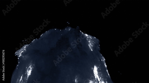 A blacklit verticle fountain splashes against a black backround. photo