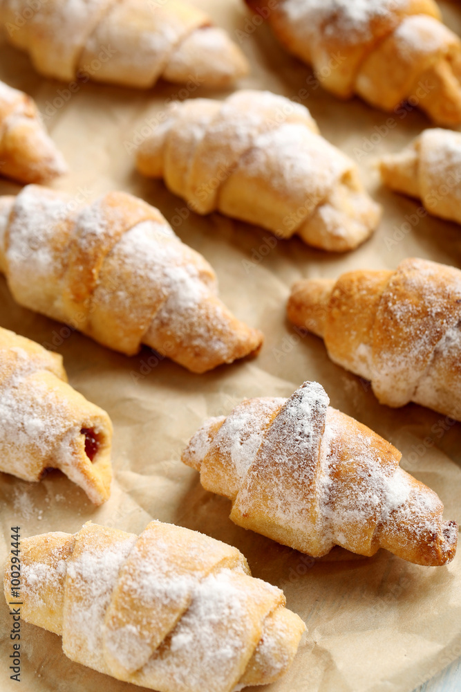 Fresh homemade croissants on a brown parchment Fresh homemade croissants on a brown parchment