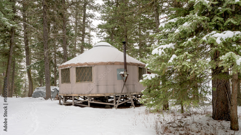 Camping yurt in winter with trees and snow
