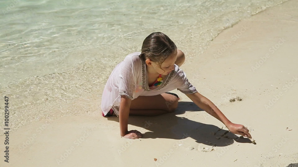 Happy child playing with sand on beach in summer. Happy child playing with sand on beach in summer.