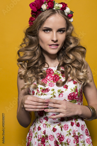 woman with long curly blond hair with luxurious flowers headband