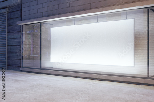 Schilderij op canvas Large blank banner in a shop window at night, mock up