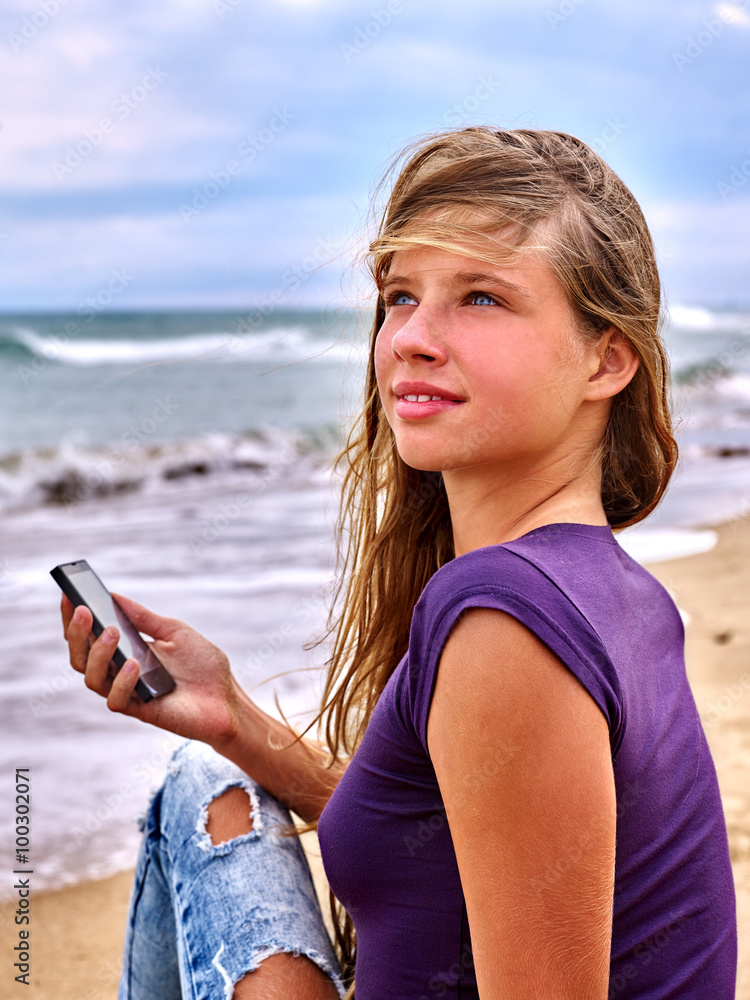 Girl call mobile phone on sand near sea. First love.