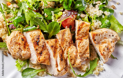 Quinoa and vegetable salad with grilled chicken photo