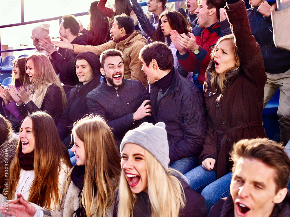 Fototapeta premium Emotion sport fans clapping and singing on tribunes. Group people.