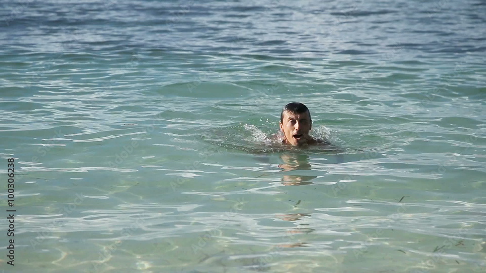 The man swims in the tropical sea The man swims in the tropical sea