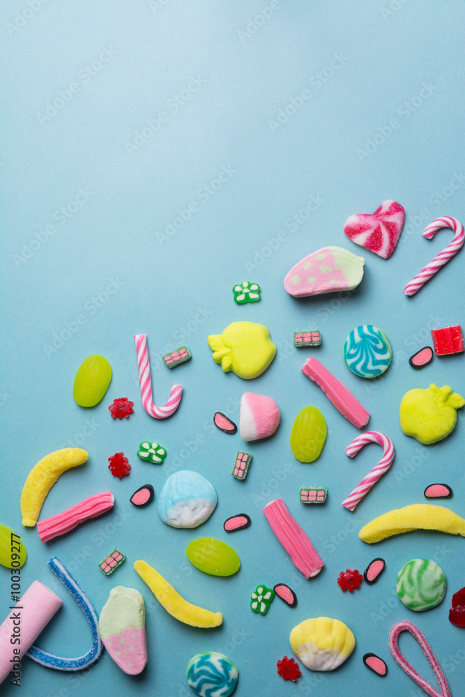 mixed collection of colorful candy, on blue background
