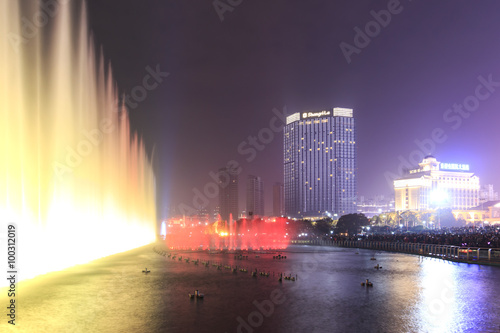 Nanchang, China - January 3, 2016: Dancing water fountain in Nanchang at night with thousands of tourists enjoying the scene