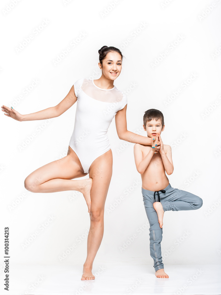Happy cheerful mother and son posing while doing exercises together