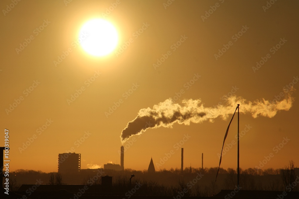 smoking factory chimneys at sunrise 