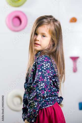 The little girl posing in a playroom photo