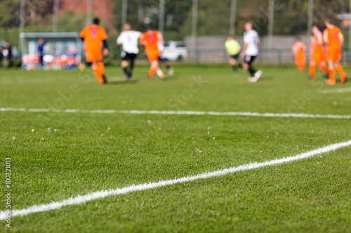 Blurred soccer players playing amateur soccer match