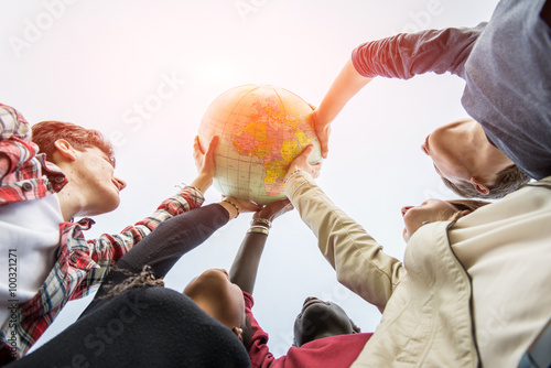 Multiracial Teen Couple Holding Globe Map - stock
