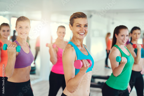 Group of young women doing dumbbells