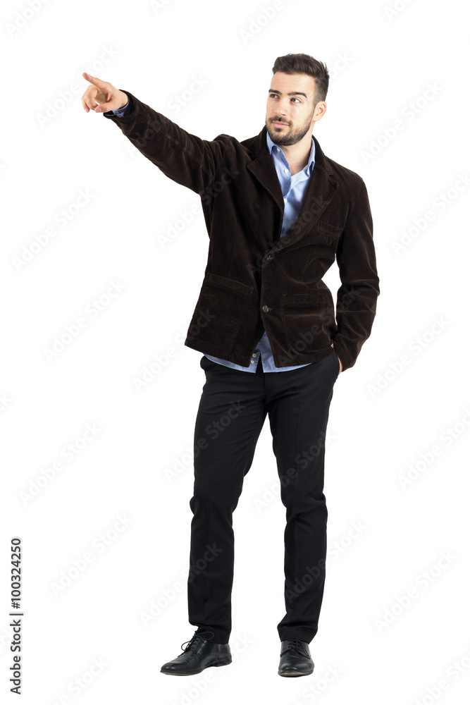 Confident relaxed man directional pointing at distance looking away. Full body length portrait isolated over white studio background. Confident relaxed man directional pointing at distance looking away. Full body length portrait isolated over white studio background.
