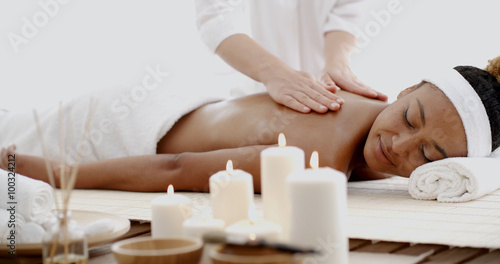 Masseur doing massage on woman body in the spa salon photo