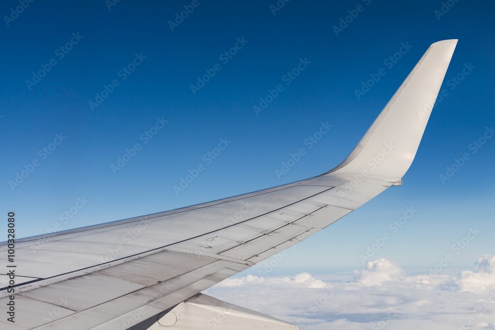 Fototapeta premium View of an airplane flying above the cloud. Look through the win