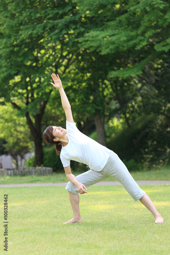 Japanese woman doing yoga triangle pose Japanese woman doing yoga triangle pose