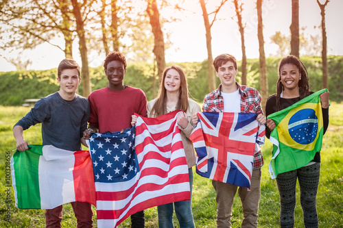 Teenage Friends Holding Flags from different Countries