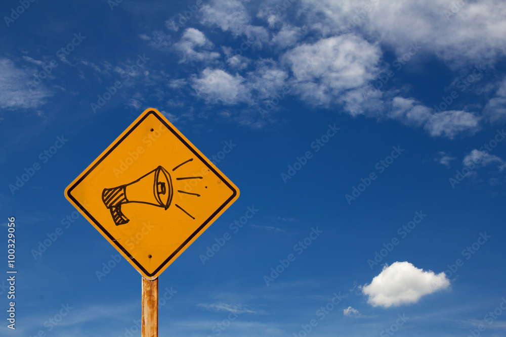 drawing of megaphone icon on yellow traffic sign drawing of megaphone icon on yellow traffic sign