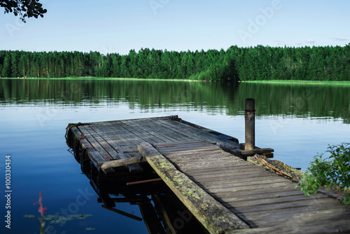 Old wooden pier on a lake at sunrise