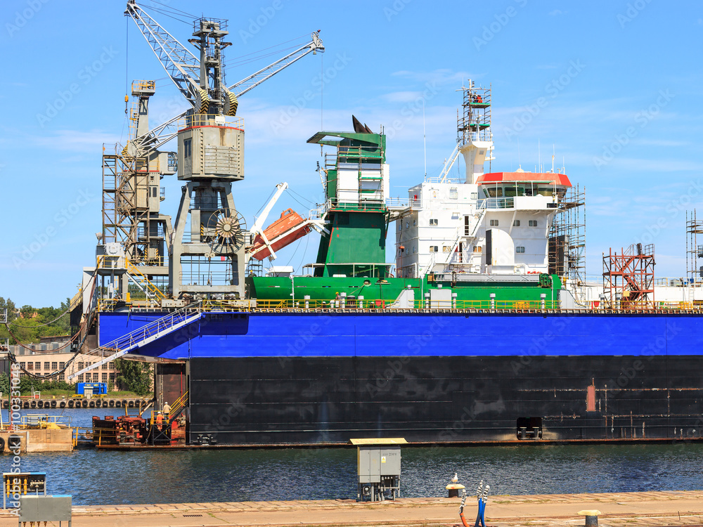Fototapeta premium A big ship on the dry dock in a shipyard Gdynia, Poland.