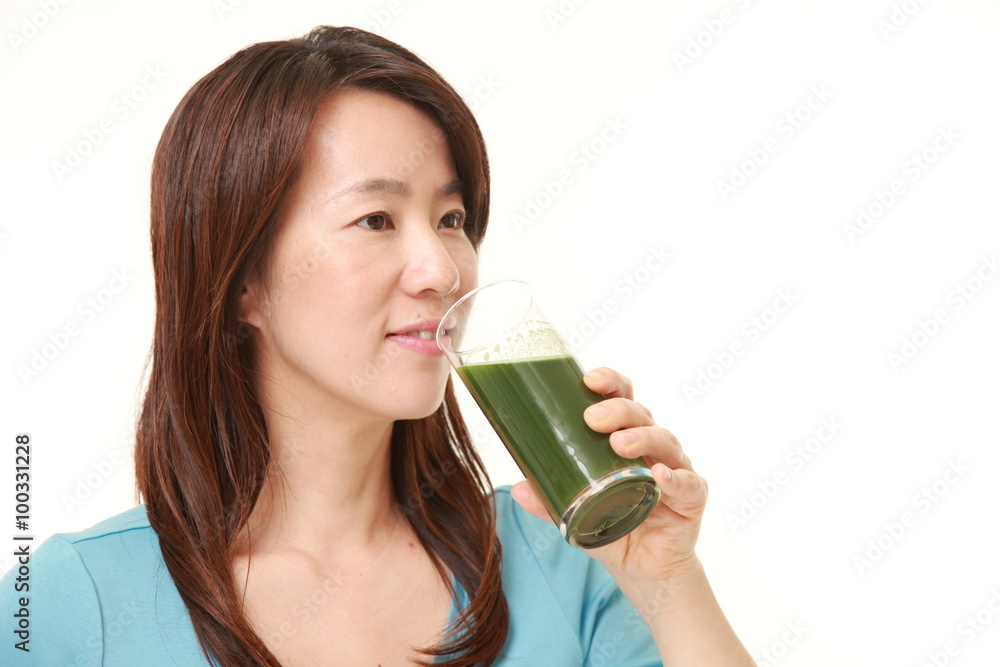 Japanese woman with green vegetable juice Japanese woman with green vegetable juice