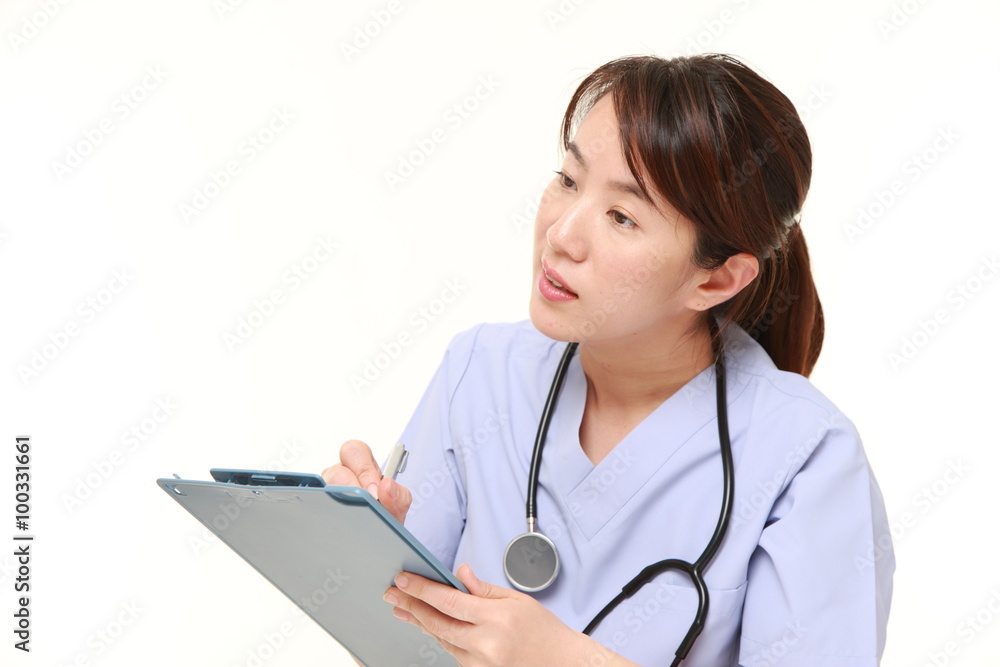 Japanese female doctor fills in clinical record Japanese female doctor fills in clinical record