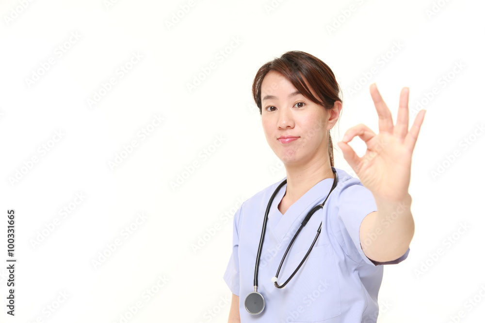 Japanese female doctor showing perfect sign Japanese female doctor showing perfect sign