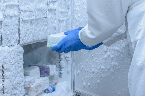 Canvas Print Scientist is putting frozen samples into freezer