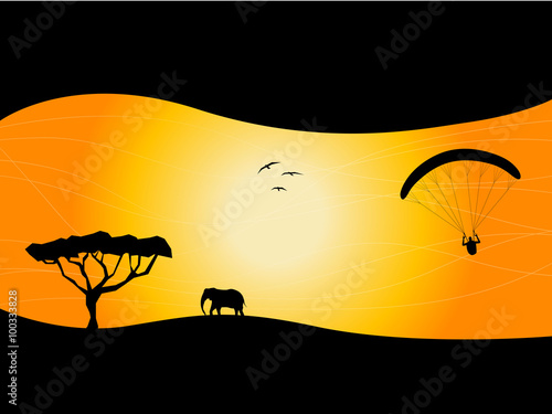 Silhouettes of paragliding with elephant