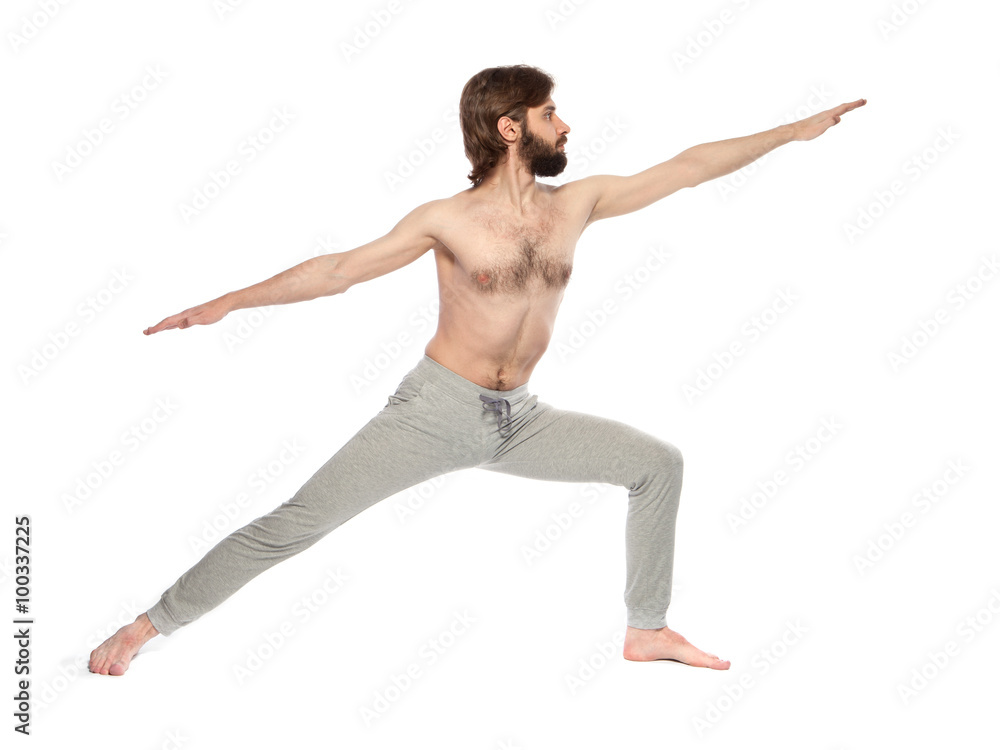 Young man with beard doing yoga on a white background