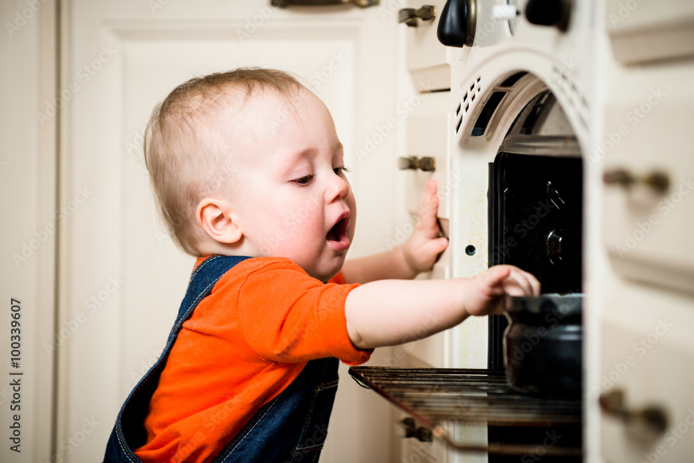 Unguarded baby with open oven Unguarded baby with open oven